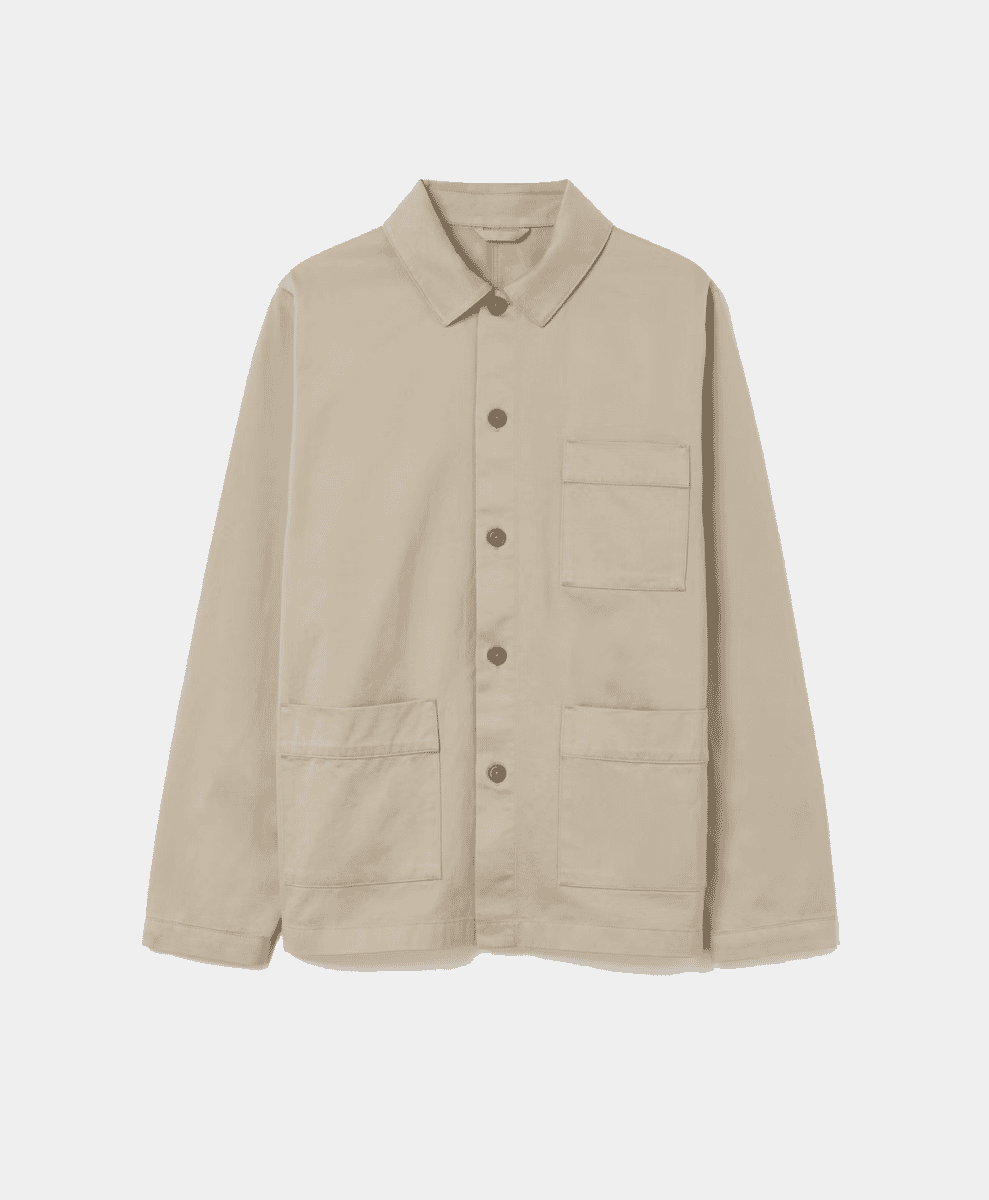 Flat-lay of a beige utility work jacket with four patch pockets and button-front closure.