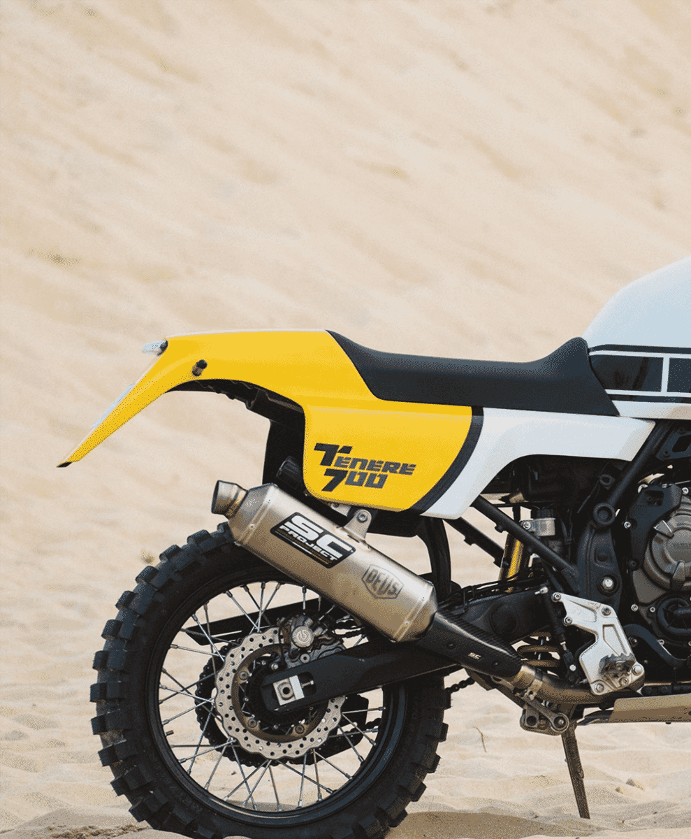 Detailed view of the SC Project titanium exhaust system and rear off-road tires.