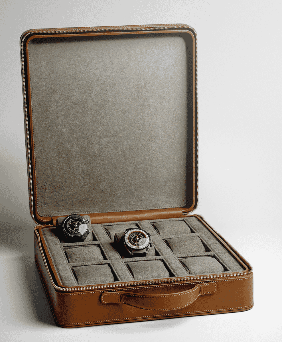 A luxury brown leather watch case holding two high-end watches on velvet lining.