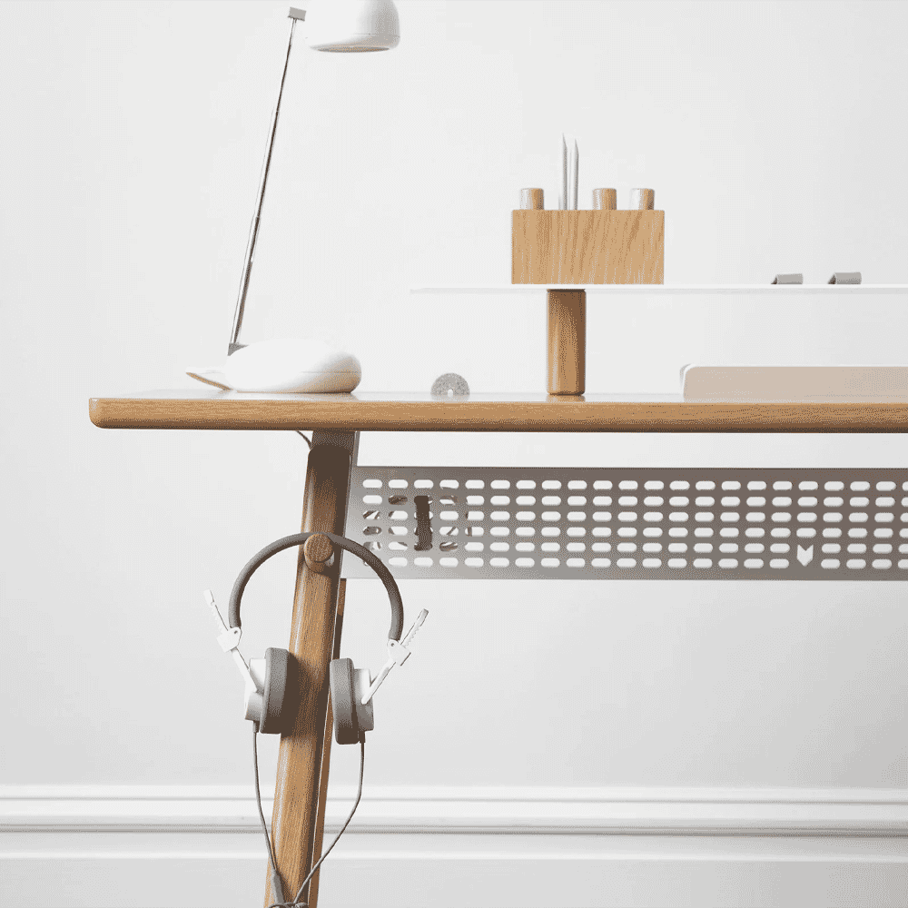 Minimalist desk setup with a white lamp and wooden surface.