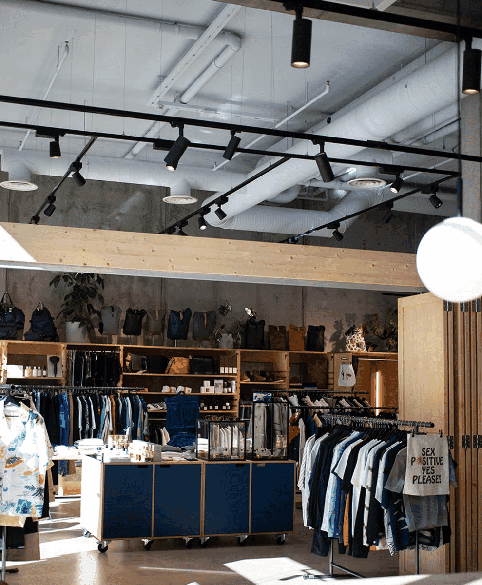 Minimalist retail space showing neutral-toned casual wear on display.