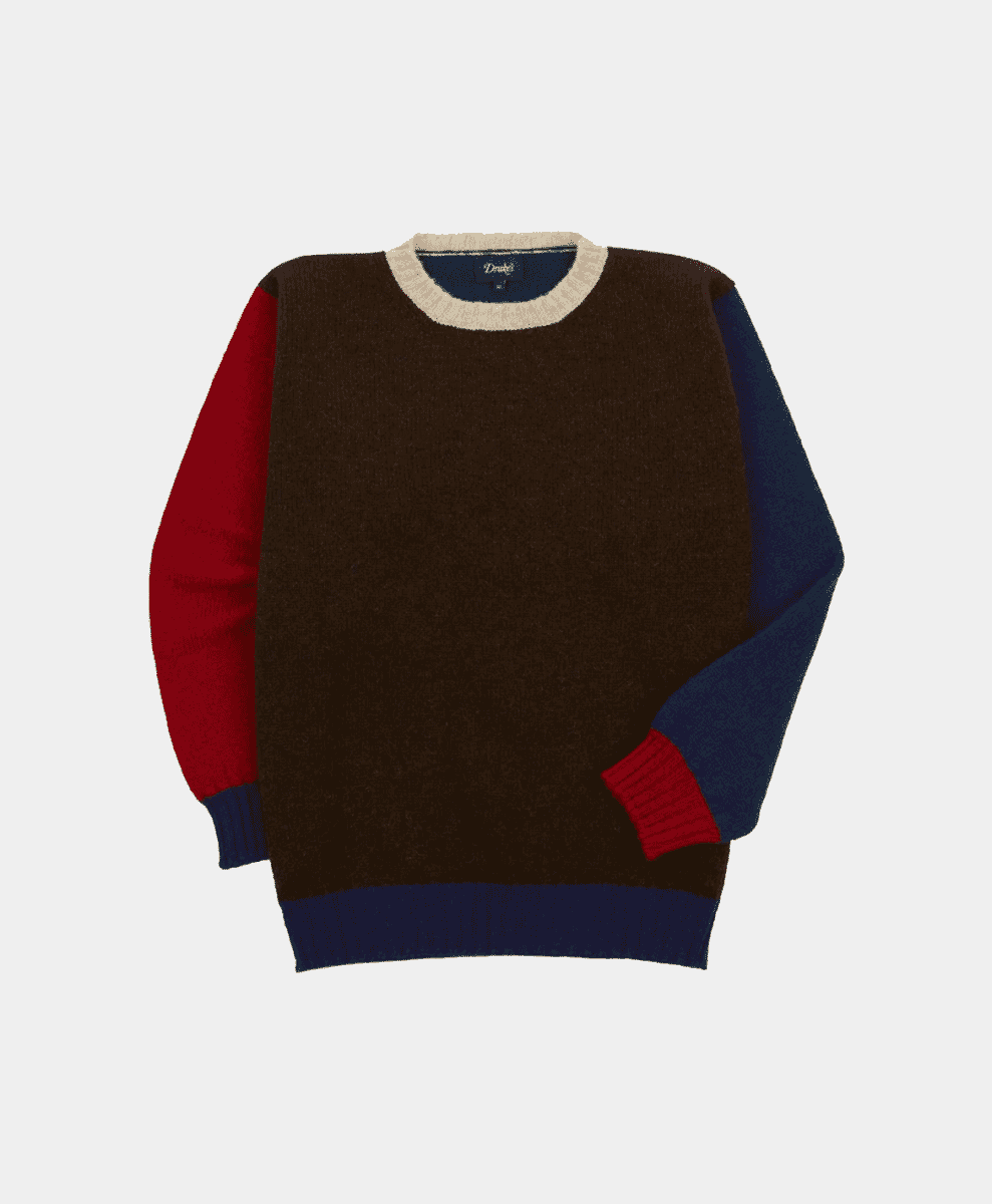 A color-block knit sweater with brown, red, and navy panels.
