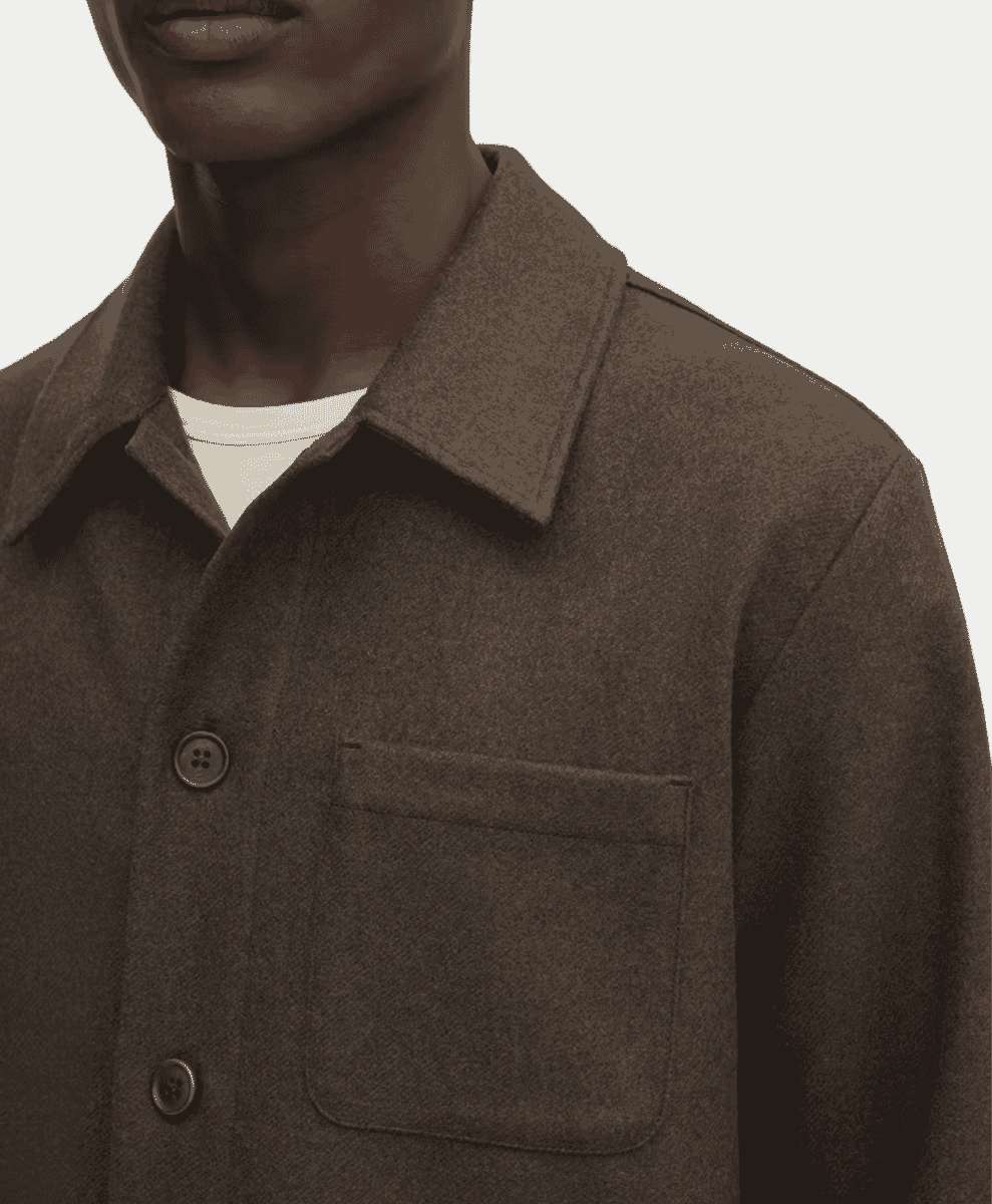 Close-up of a brown textured wool jacket layered over a white t-shirt.