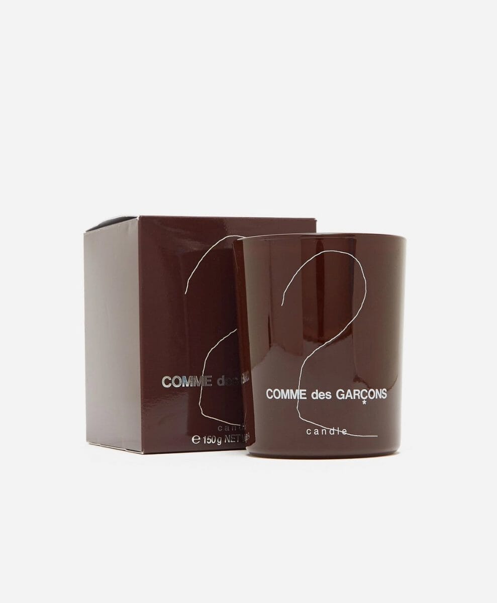Comme des Garçons branded candle in a dark brown jar with matching box.