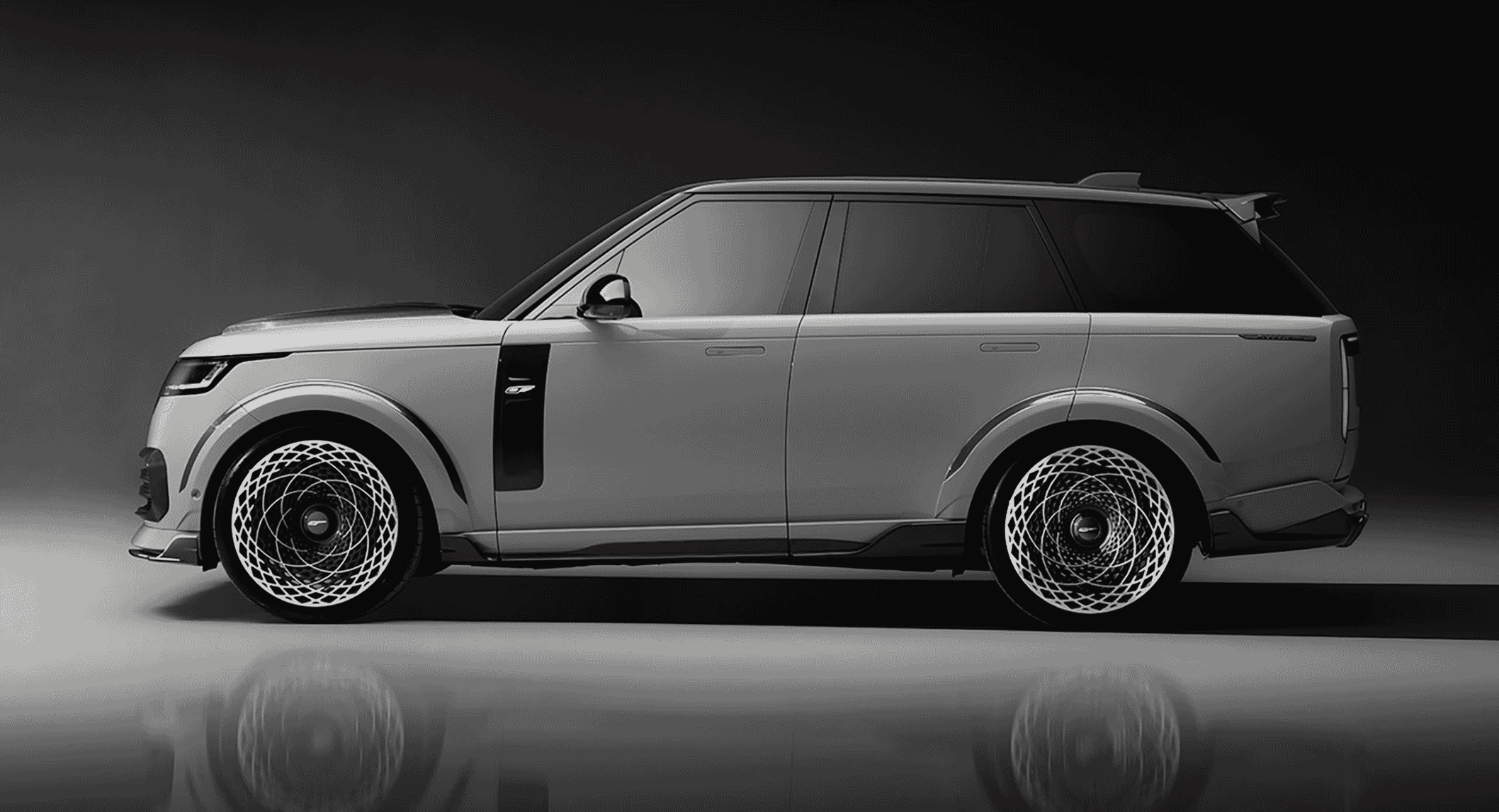 Side-angle view of a silver luxury SUV emphasizing its sleek lines and monochrome finish.