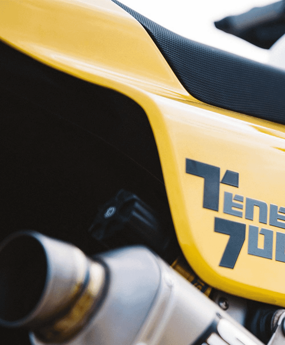 Close-up of the yellow fuel tank featuring 'TEN 700' graphics and mechanical details.