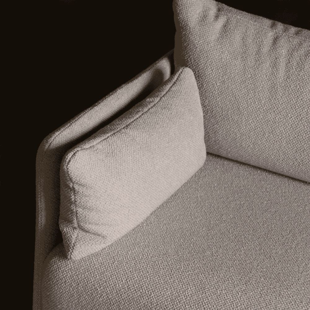 Macro view of light beige textured fabric upholstery against a dark background.