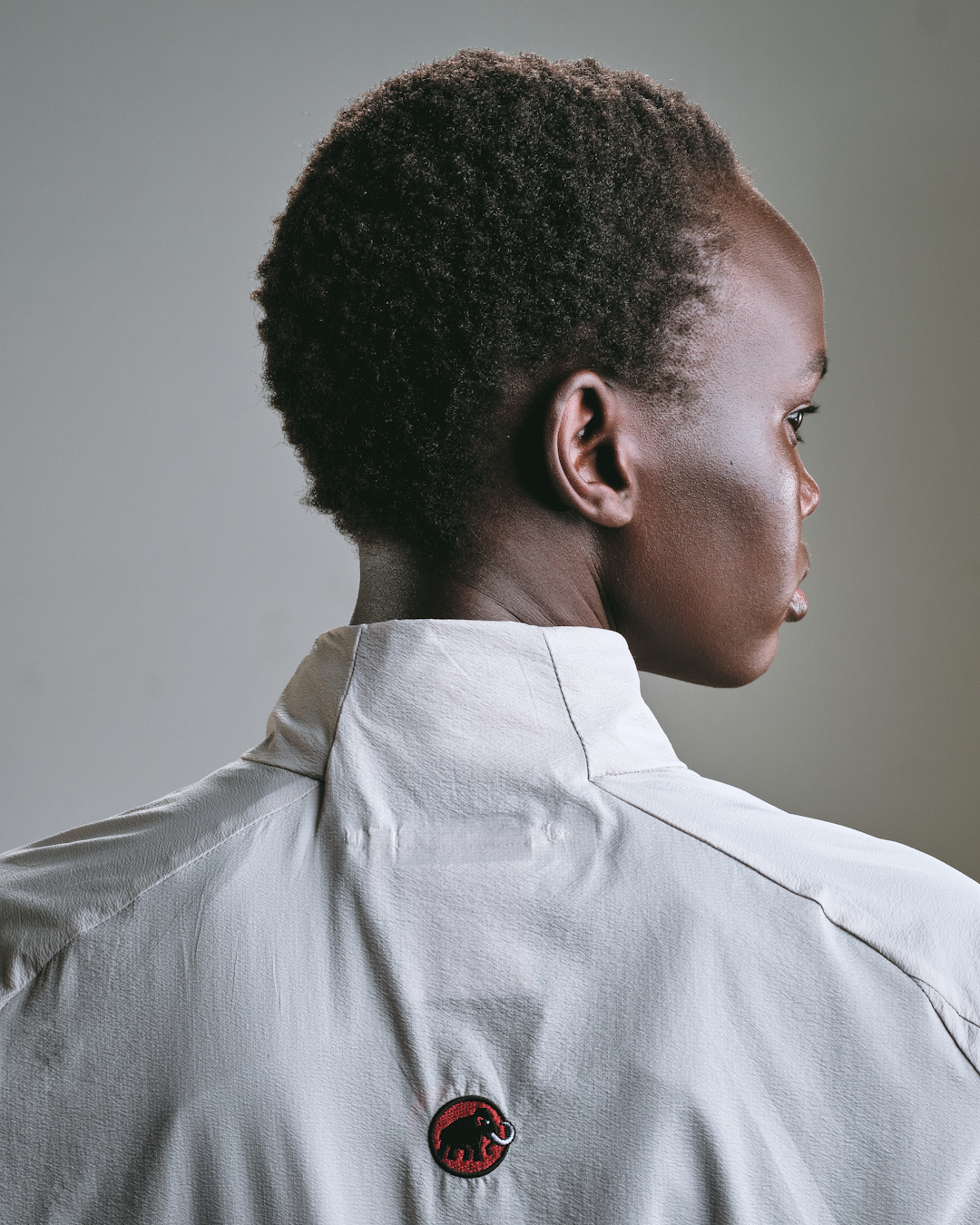 Close-up of sand and charcoal colored technical fabrics layered together.