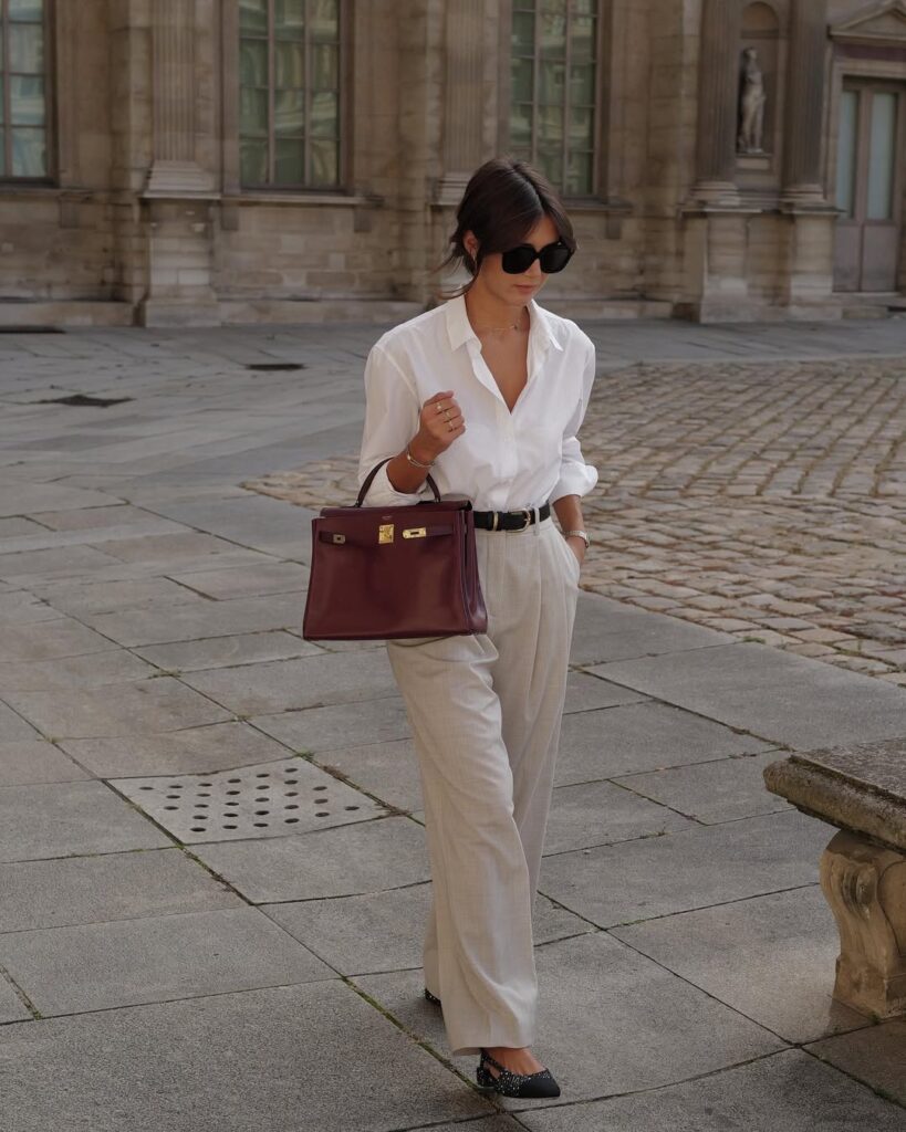 Model wearing high-waisted wide-leg trousers paired with a slim-fitting top.