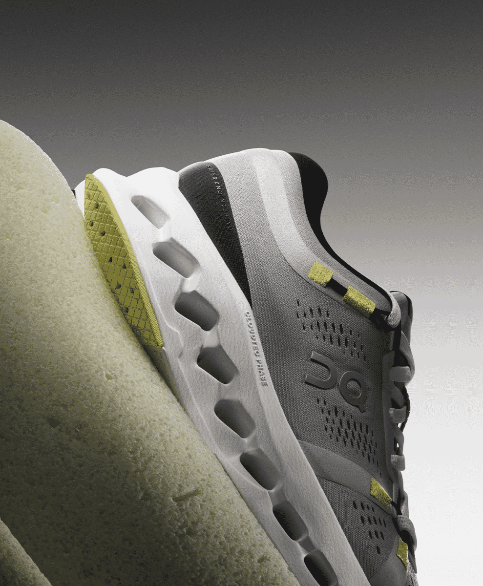 Close-up of the perforated grey mesh upper and yellow accents of the Cloudsurfer 2.