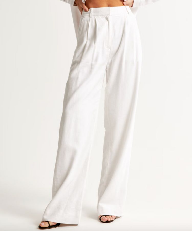 Tailored ivory linen-blend trousers with a high-waisted fit.