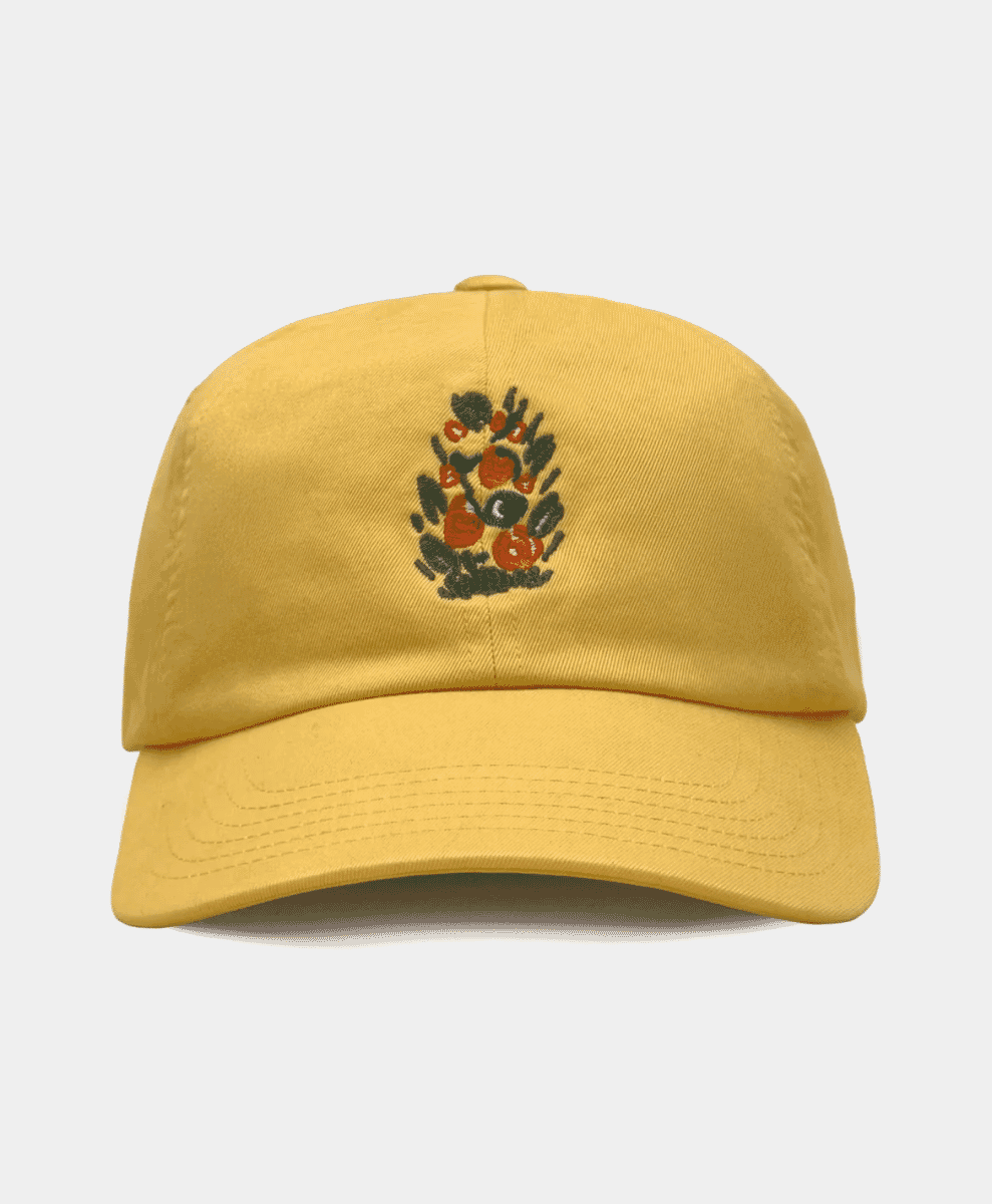 Mustard yellow cap with small floral embroidery.