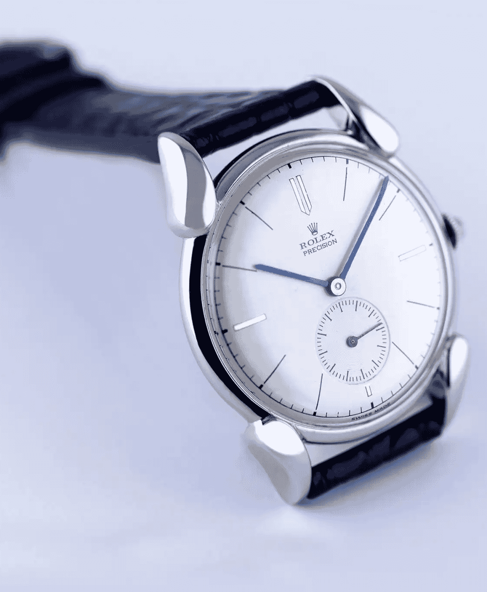Macro shot of a Rolex Precision featuring a white dial and distinctive blue hands.