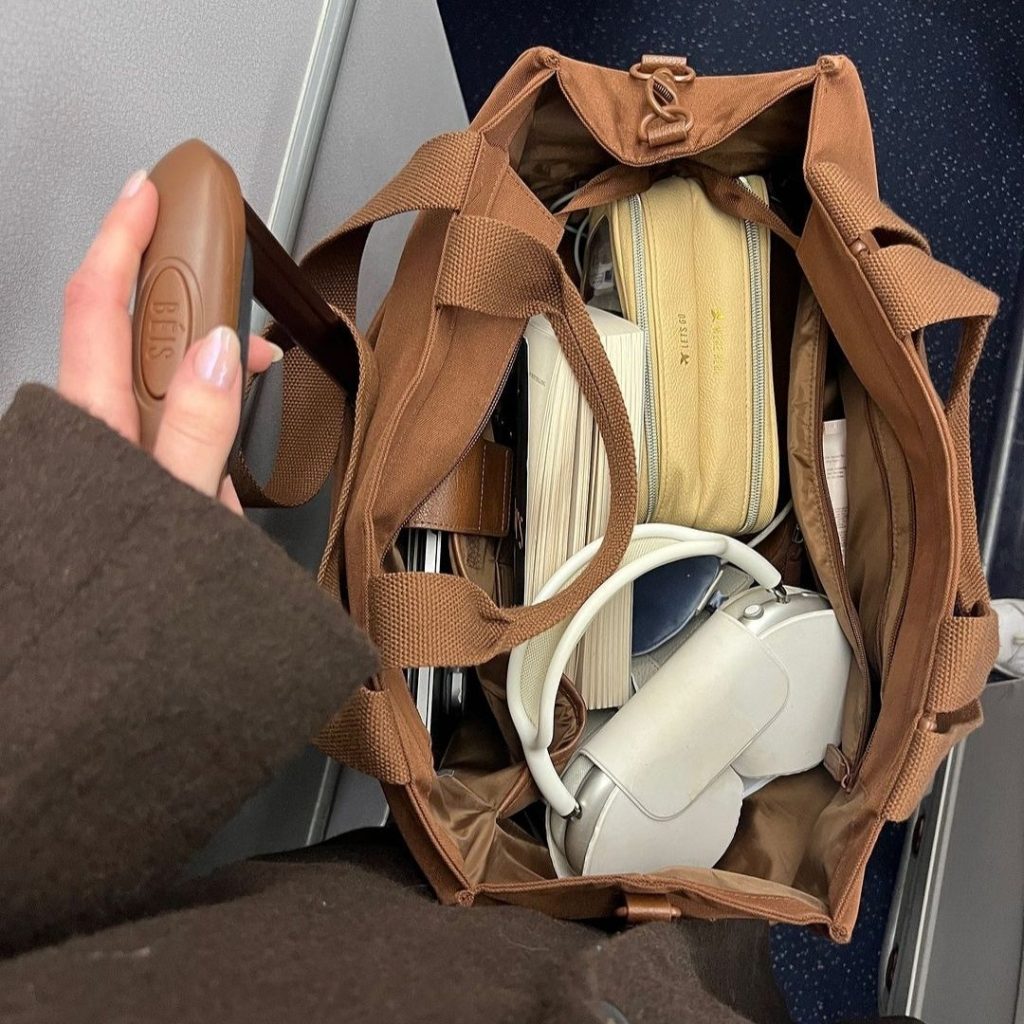 A woman styled in a neutral, sophisticated outfit perfect for European city streets.