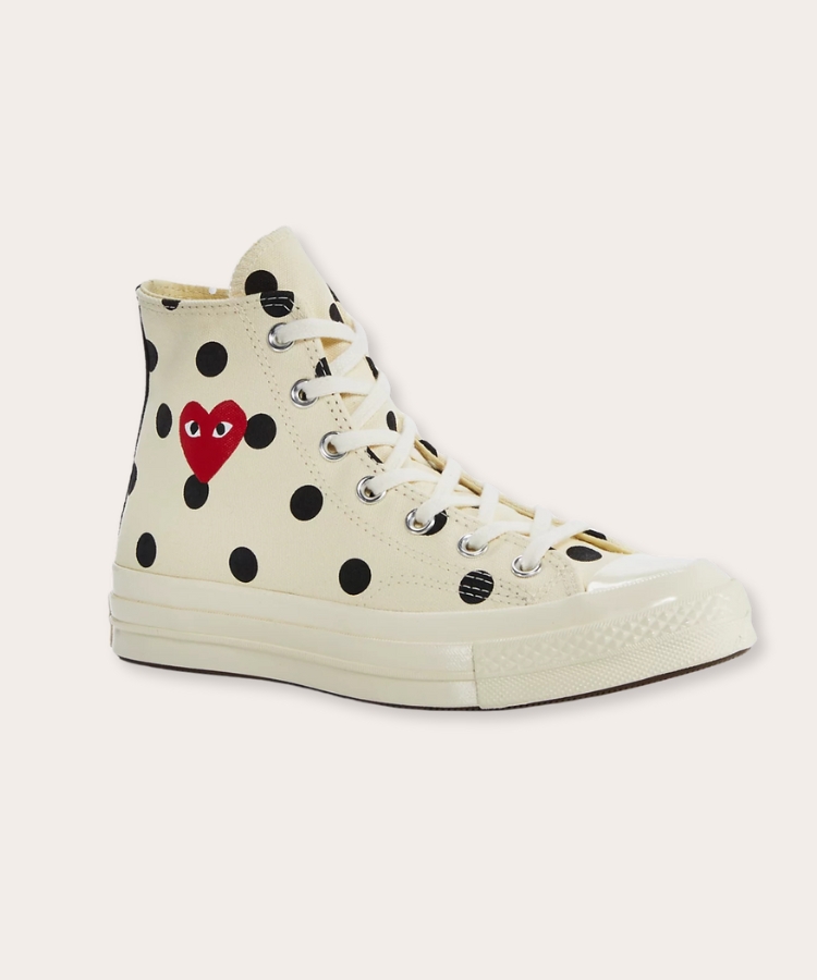 High top sneakers with a red heart logo on the side.