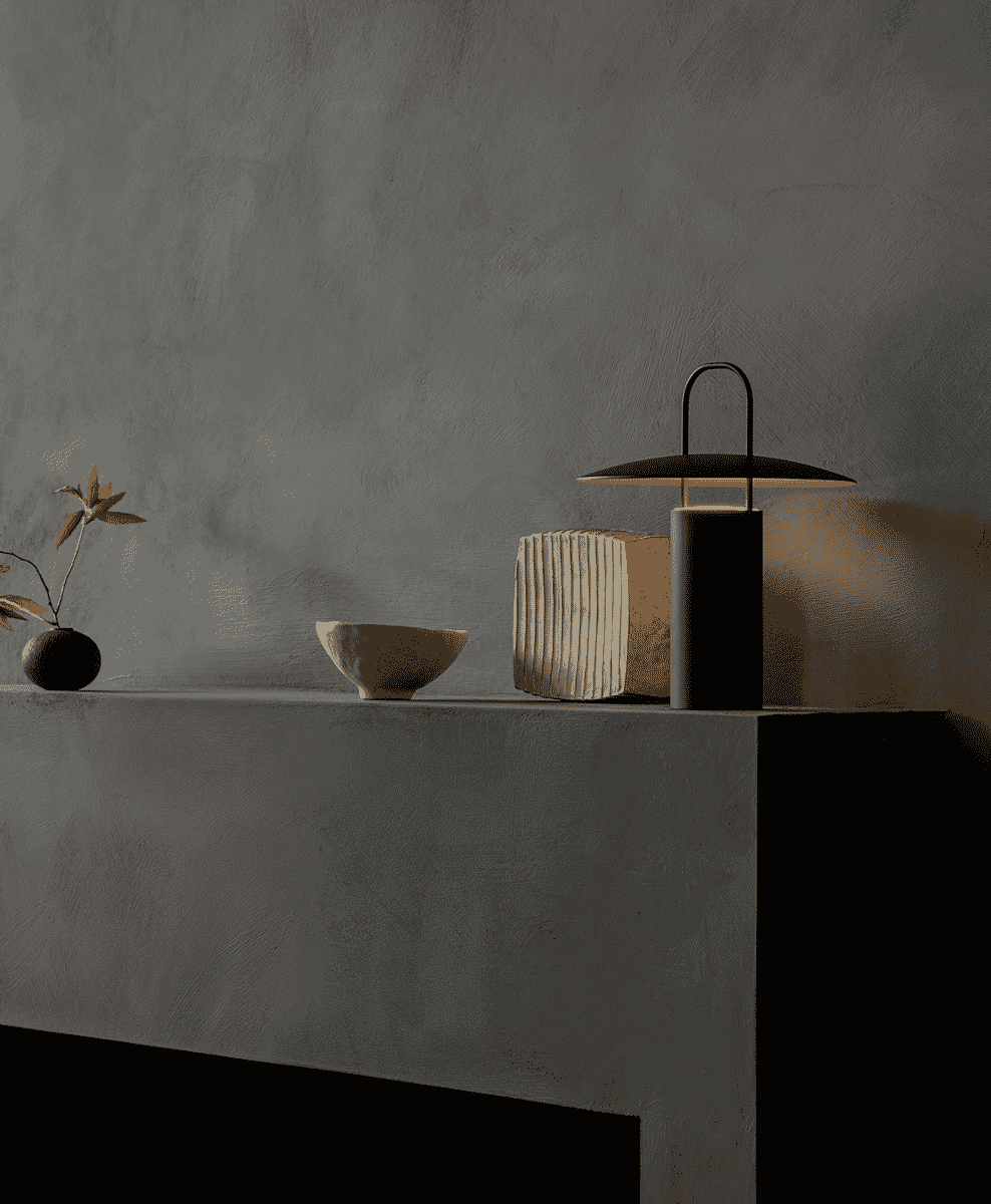 An Audo Copenhagen Ray Portable Lamp on a concrete shelf.