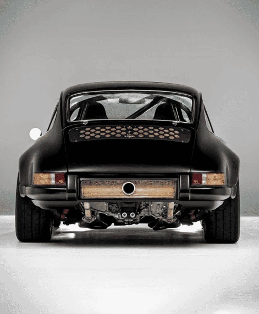 Rear view of a black classic Porsche with exposed performance exhaust.