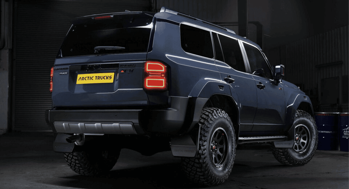 Rear three-quarter view of the Arctic Trucks SUV showing the custom bumper and illuminated taillights.