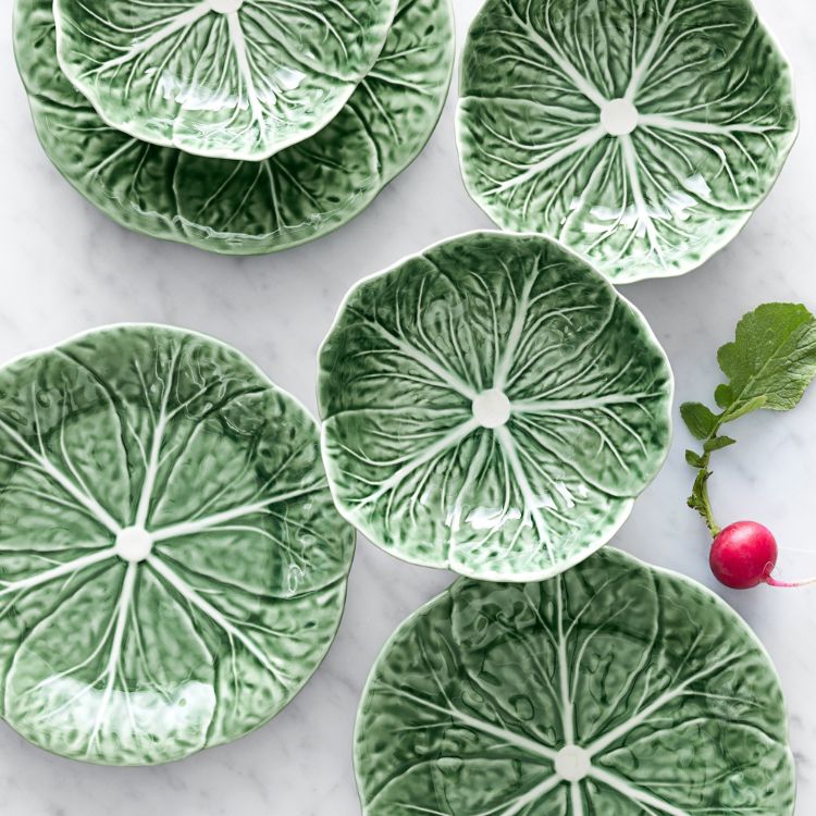 A green ceramic plate shaped like a cabbage leaf.