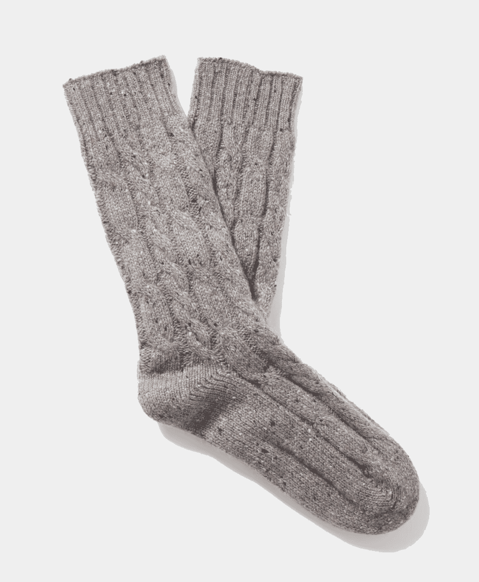 A pair of gray cable-knit wool socks with speckled texture.