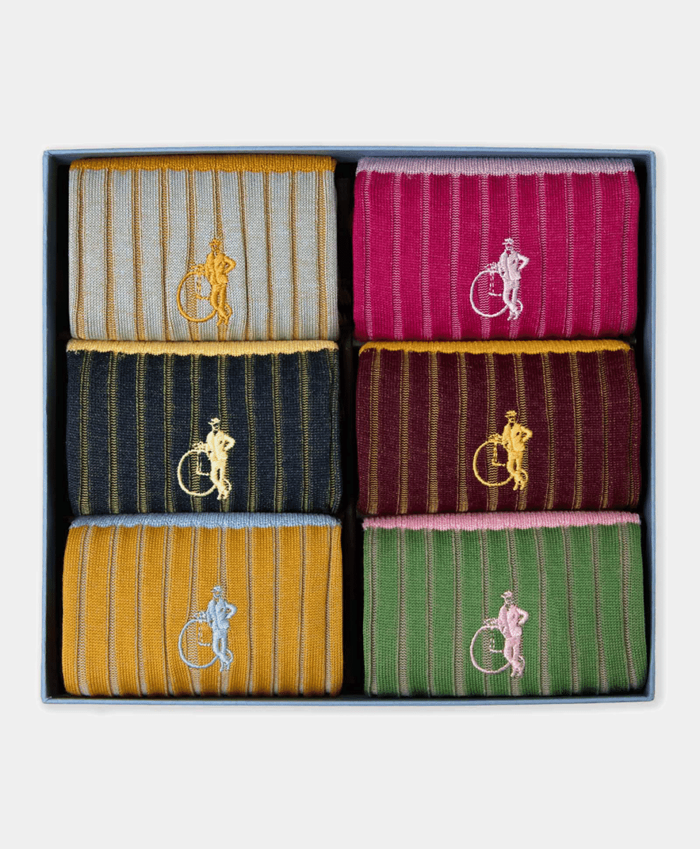 A gift box containing six pairs of colorful striped socks with embroidered cyclist motifs.