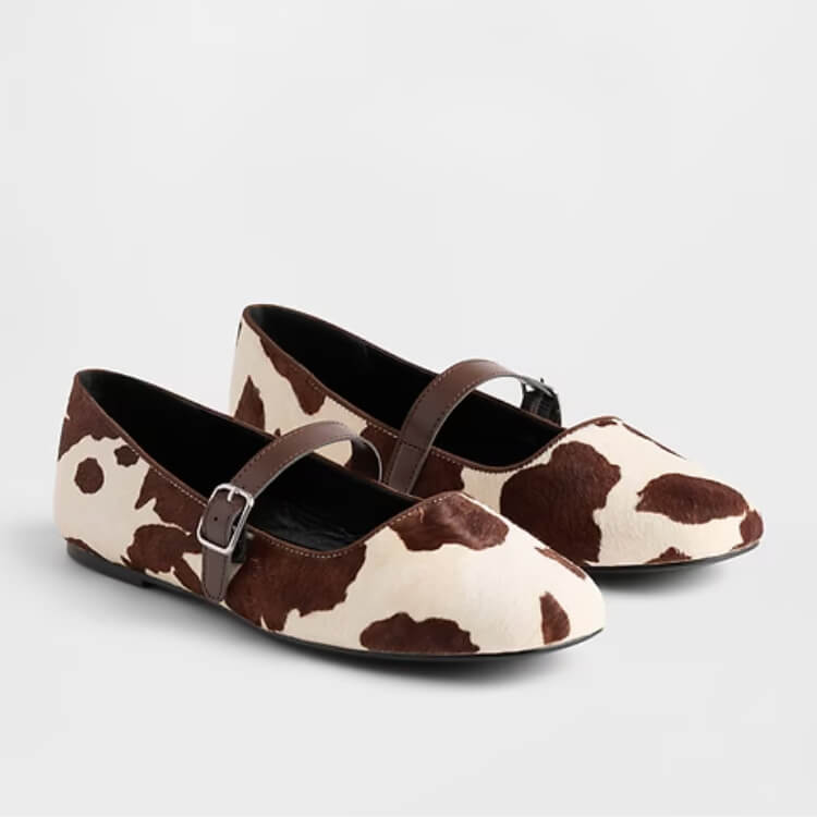 Gap Mary Jane flats featuring a striking cow print pattern.
