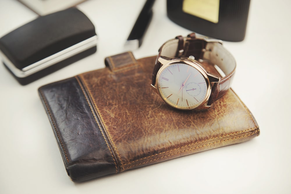 An organized dresser top featuring a wallet and grooming essentials in a clean arrangement.