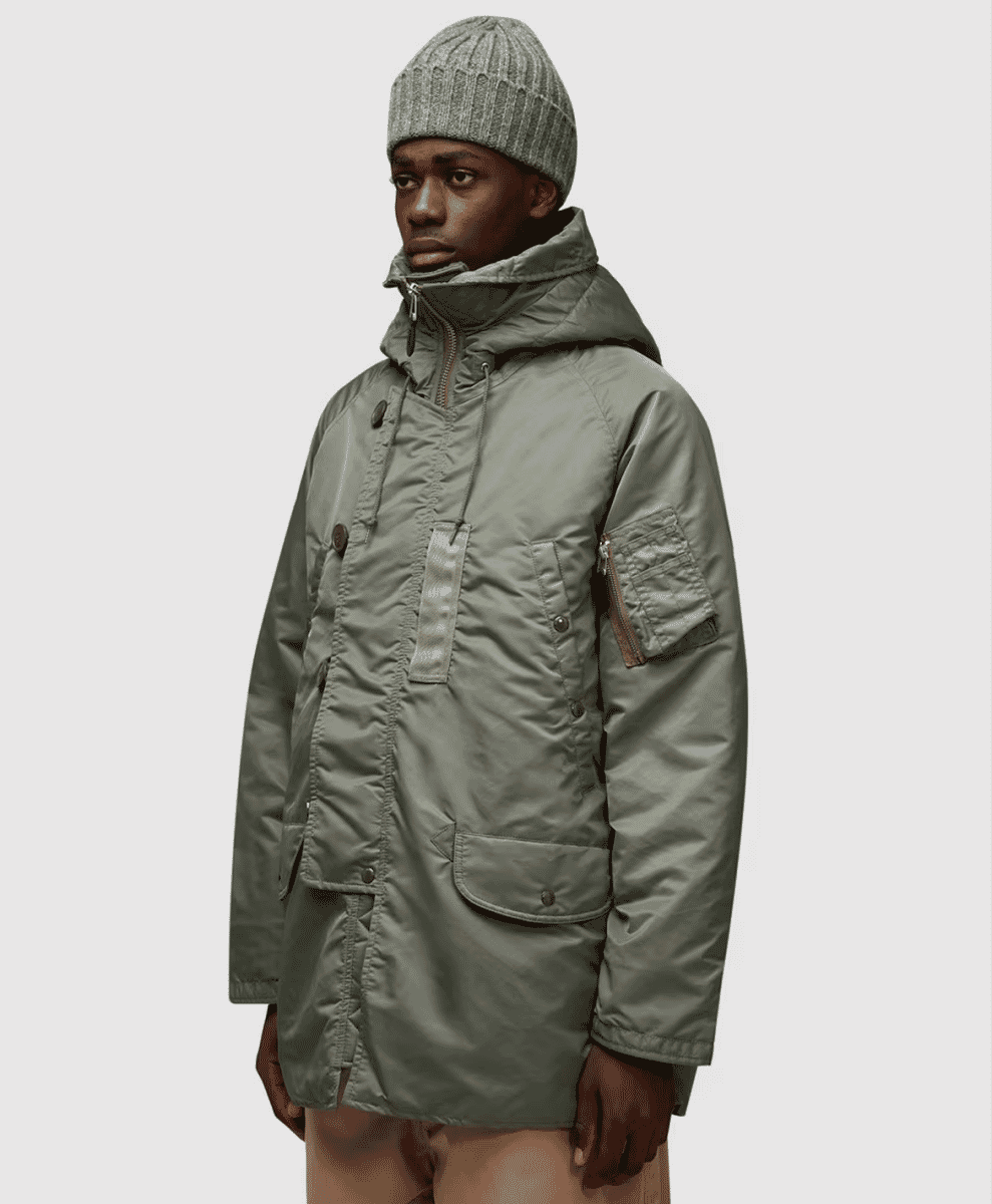 Military-inspired olive green N-3B parka with a buttoned front and patch pockets.