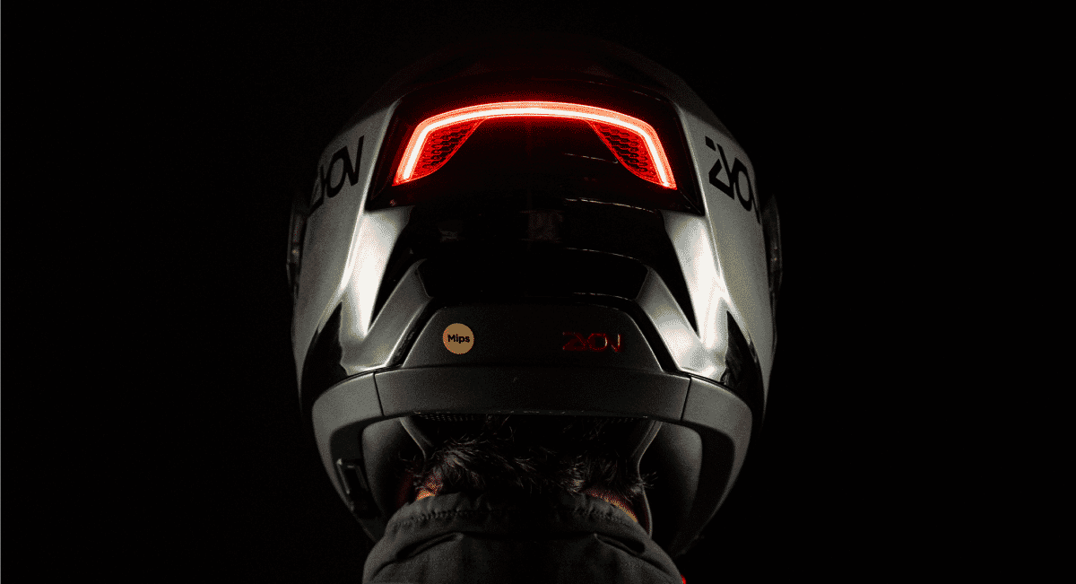 Rear view of a silver ZYON helmet featuring illuminated red safety lights.