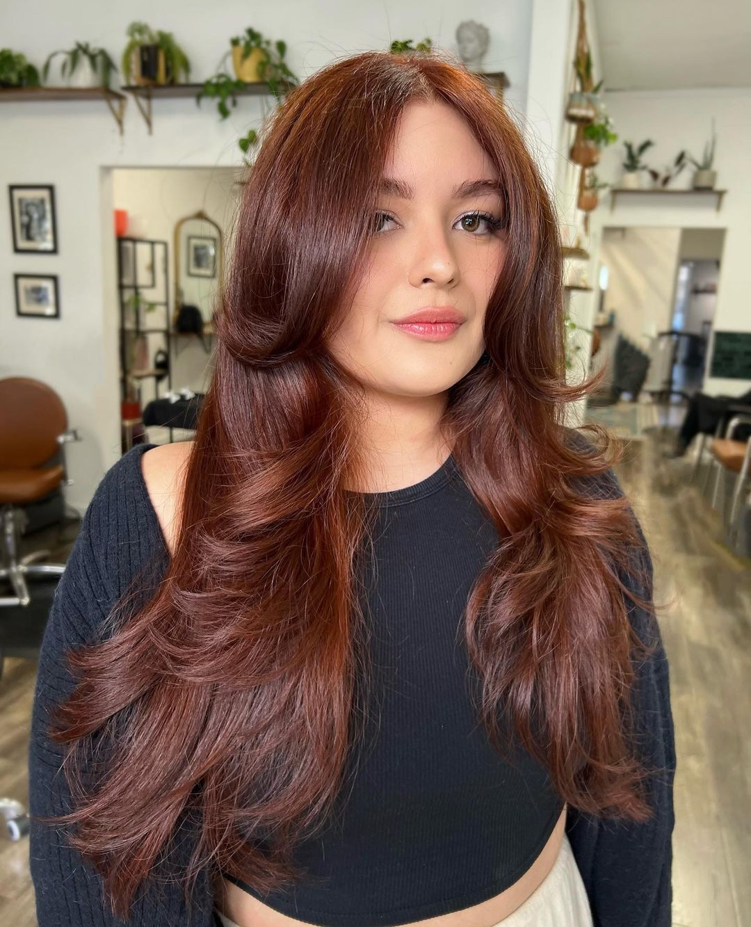 Long hair with deep red-toned copper reflections and chocolate undertones.