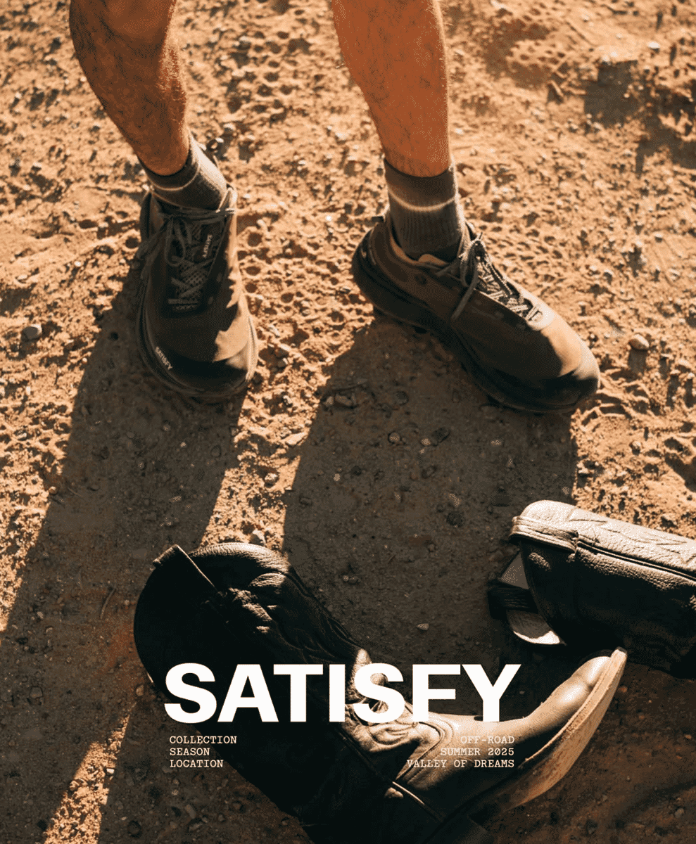 Close-up of hiking shoes and socks on dusty, rugged off-road terrain.