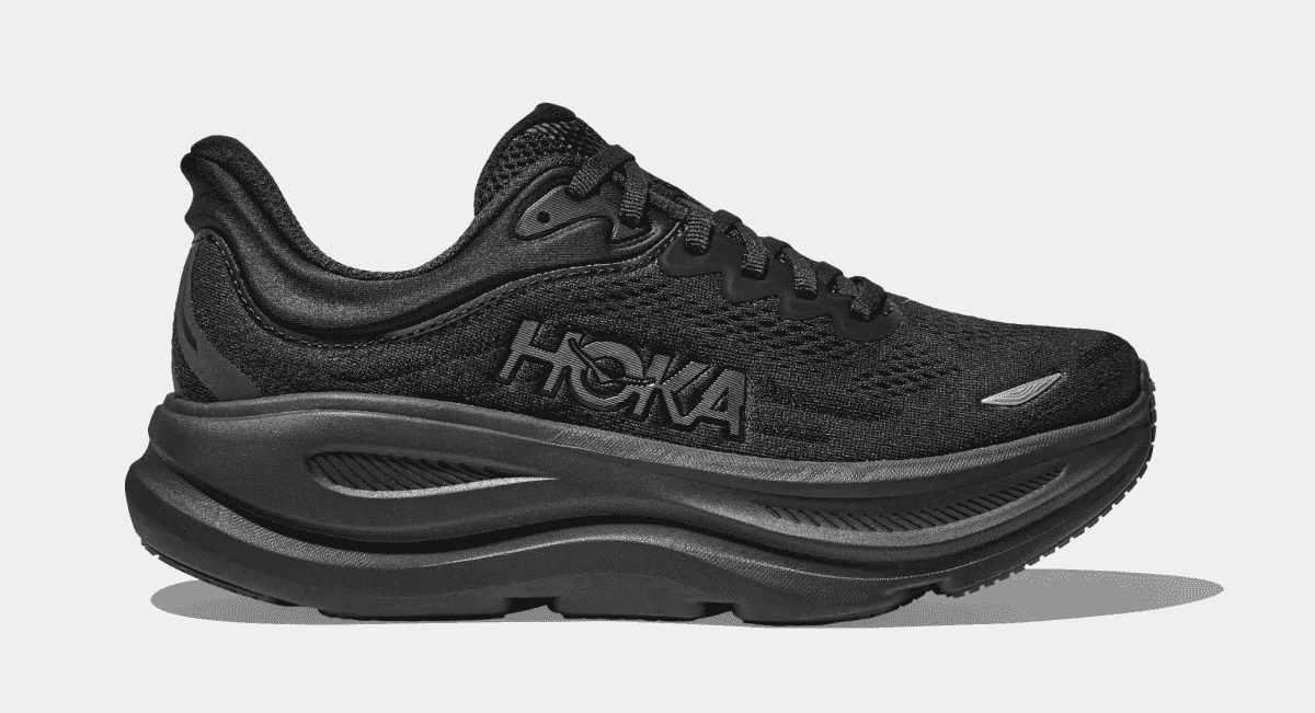 Side profile of a black Hoka running shoe with a thick cushioned sole against a white background.