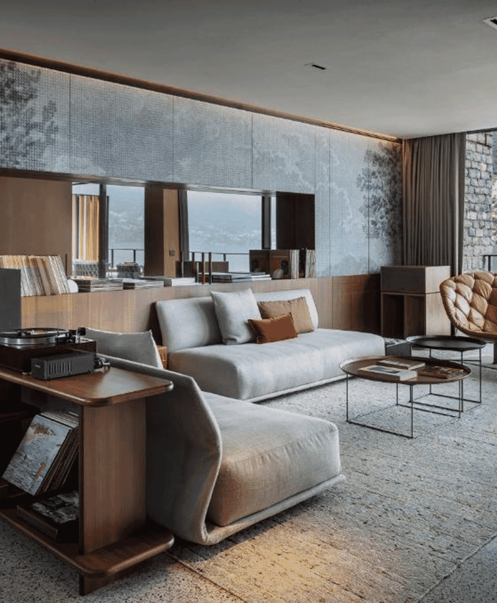 Luxury living room designed by Patricia Urquiola with a light gray sectional sofa and acoustic wood paneling.