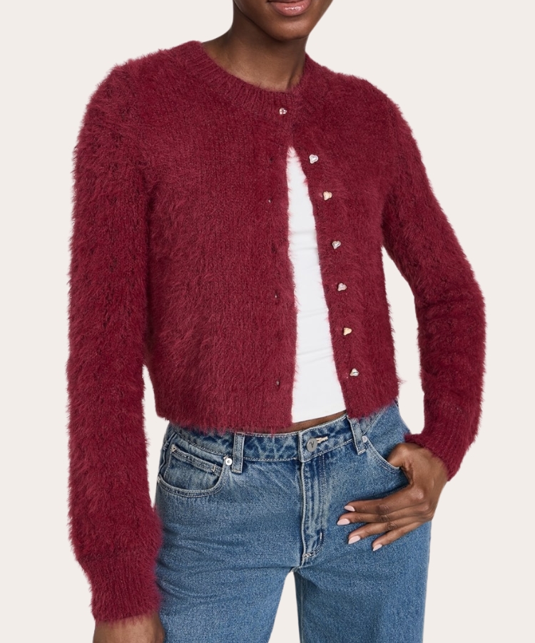 Fuzzy knit cardigan in a warm red tone.