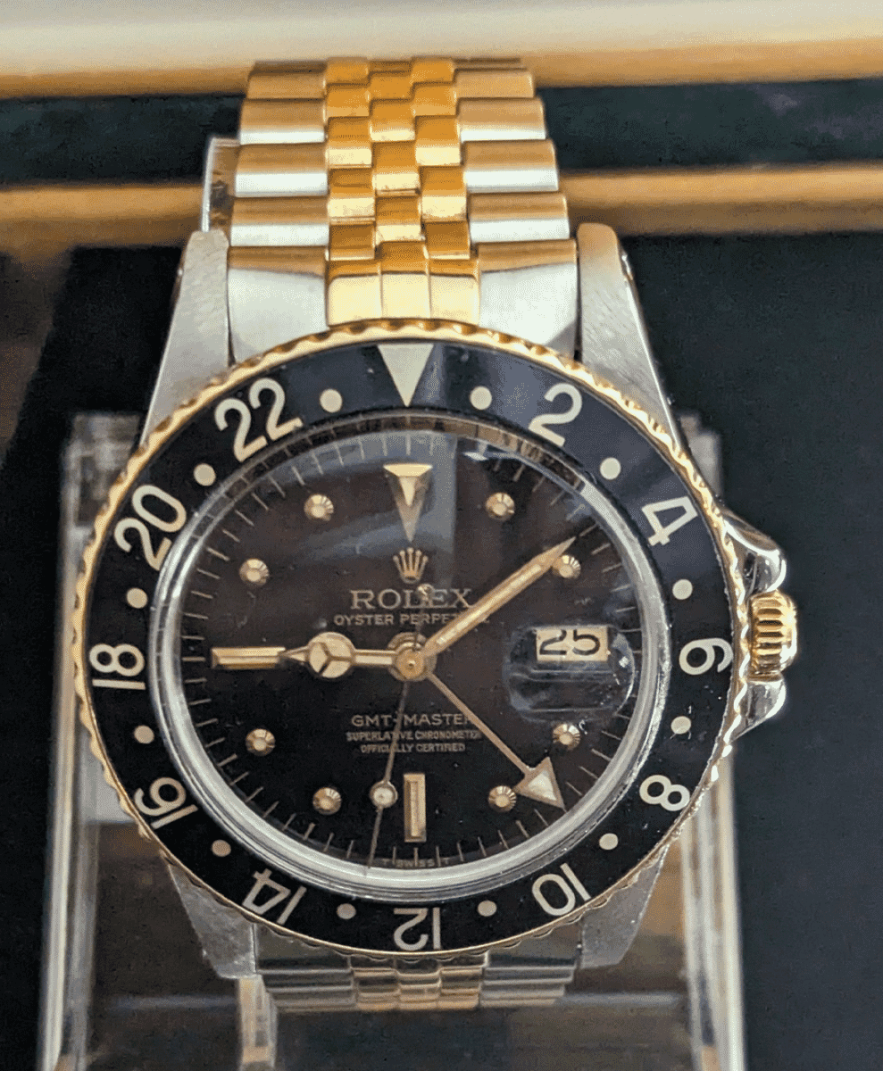 Rolex GMT-Master in gold and stainless steel, highlighting the luxury travel aesthetic.