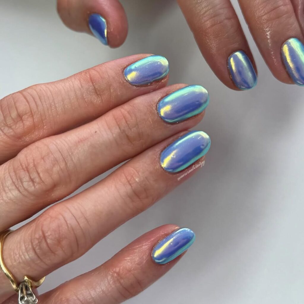 Iridescent pink-to-gold mermaid chrome nails.