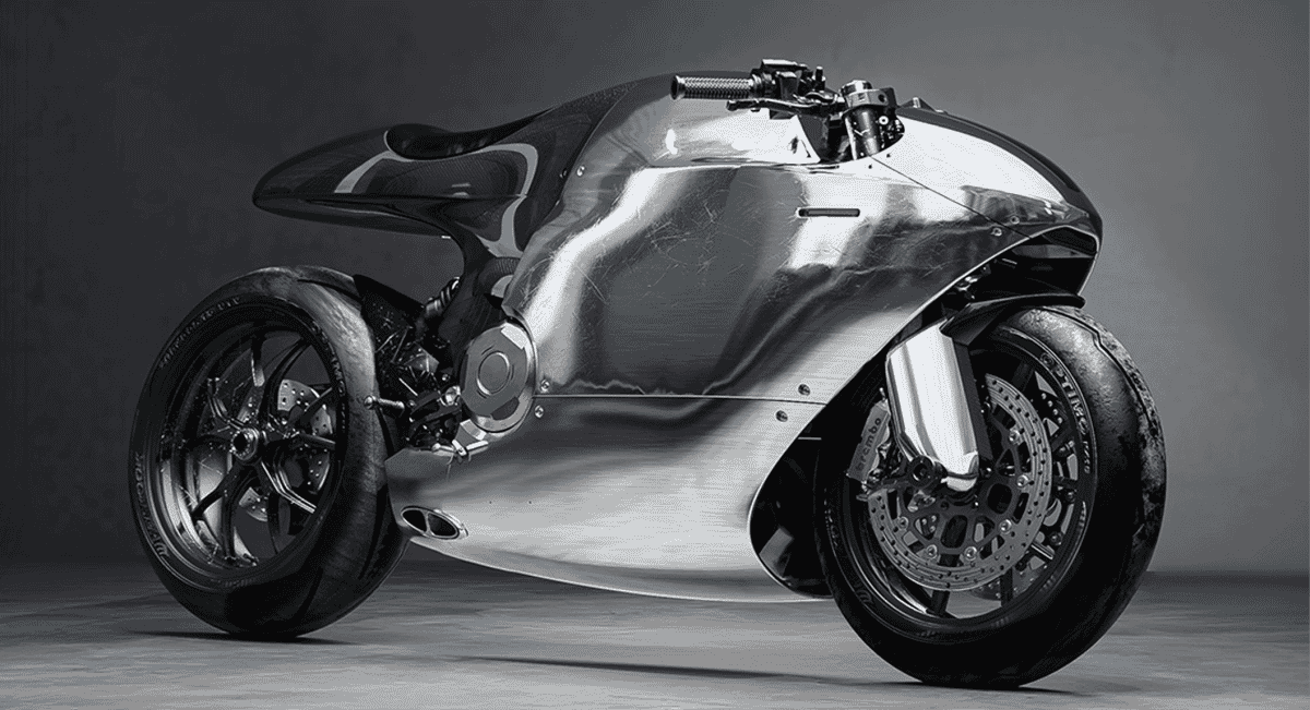Chrome motorcycle featuring aerodynamic unibody construction and exposed mechanical components under dramatic lighting.
