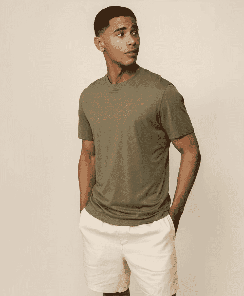 Front view of a man in an olive green t-shirt and white shorts