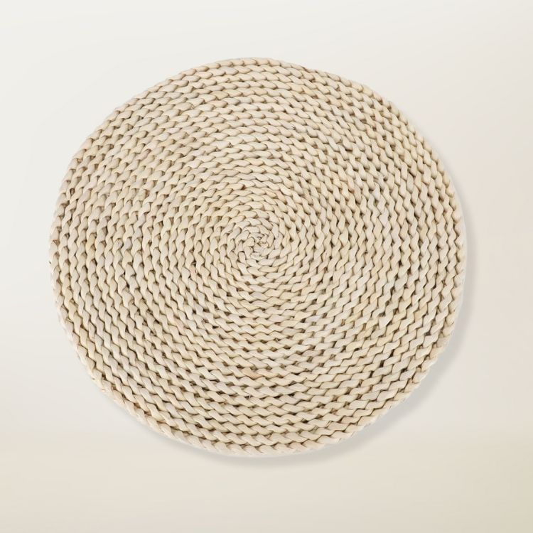 A set of round woven seagrass placemats.