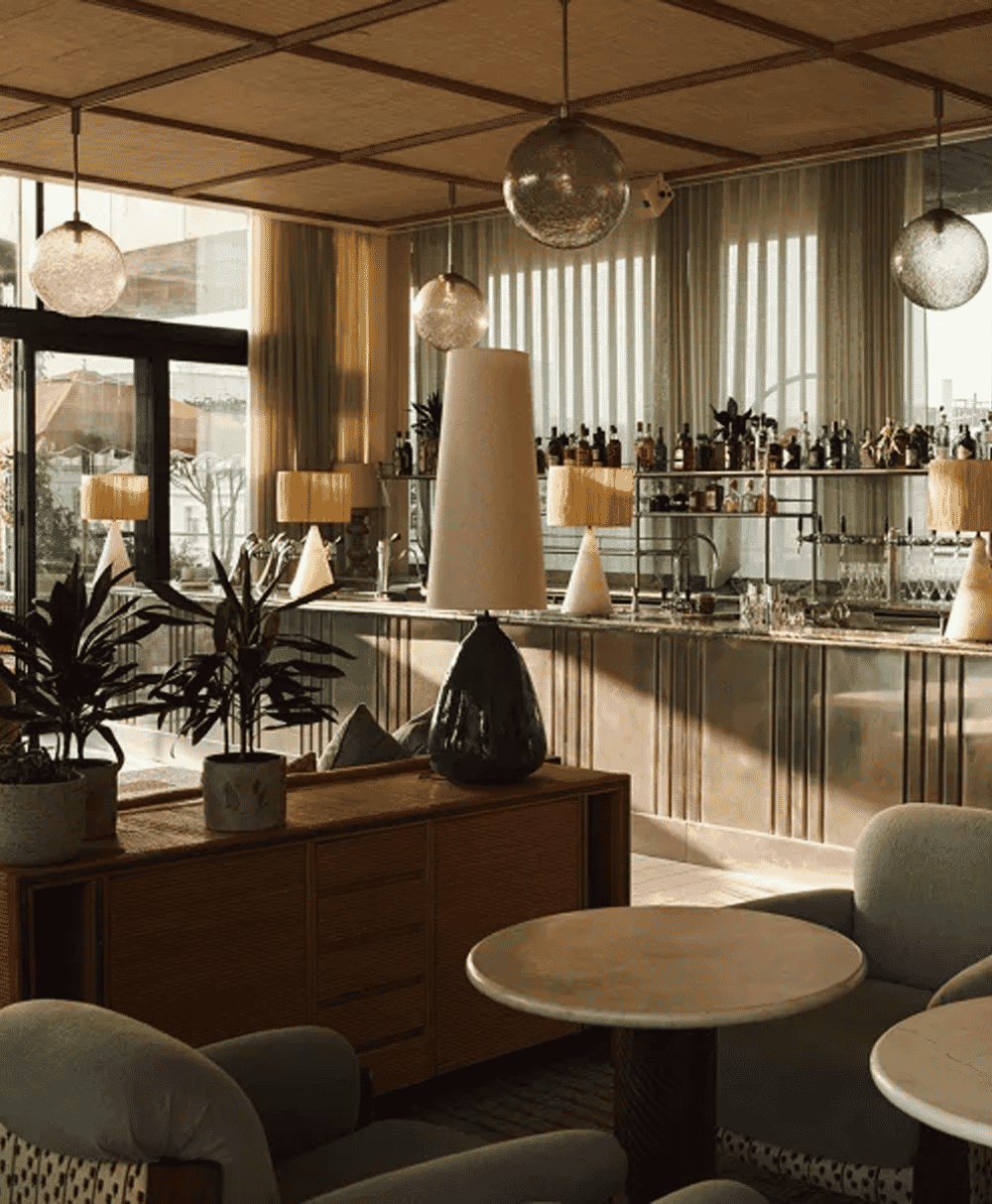 Modern bar lounge with mid-century furniture and stylish pendant lighting.