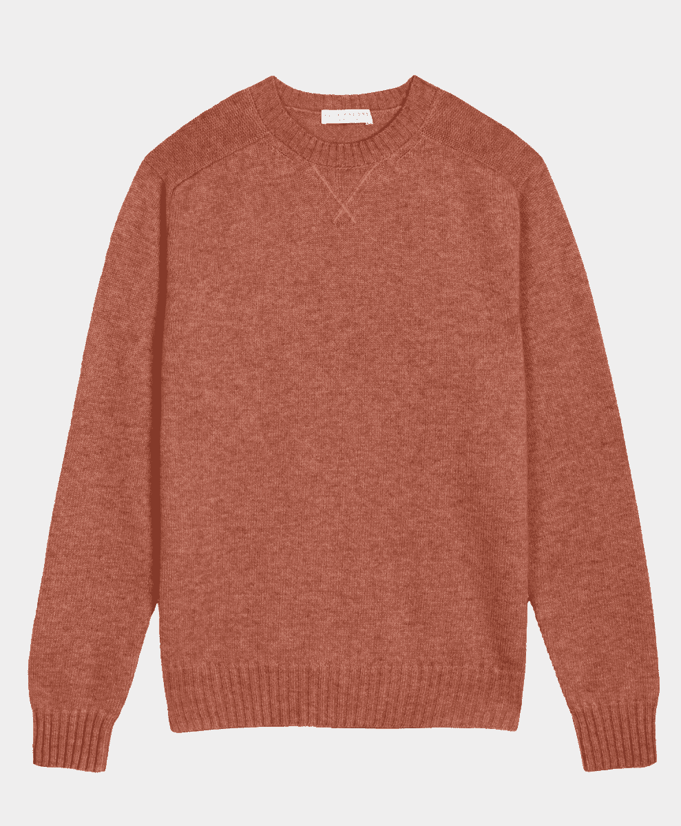 A rust-colored crewneck sweater with a minimalist knit design.