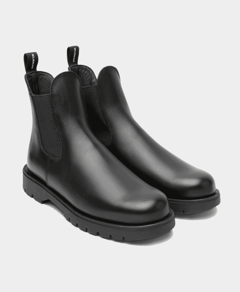 A pair of black leather chunky Chelsea boots on a white background.