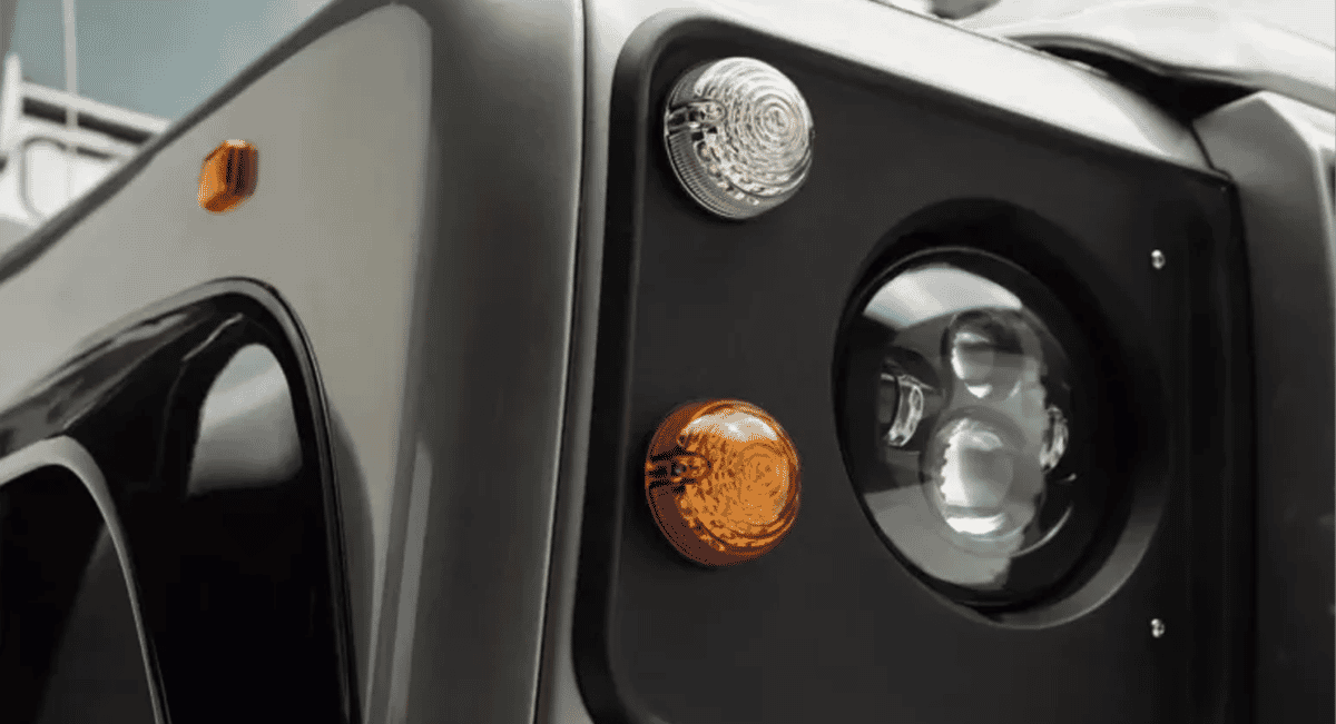 Close-up of a rugged vehicle headlight with modern lighting elements and chrome accents.