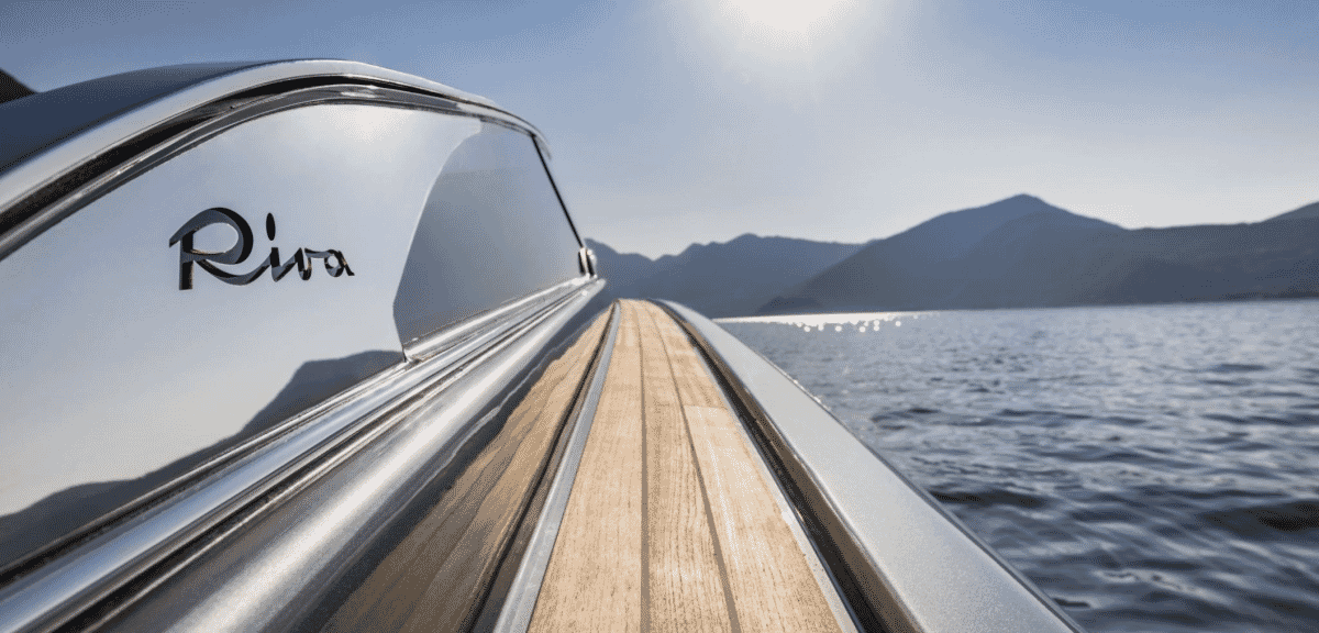 Close-up of Riva branding on a polished chrome and teak yacht bow