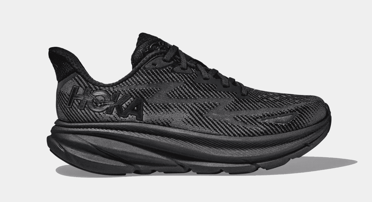 Side-profile of a black Hoka running shoe with a signature thick cushioned sole.