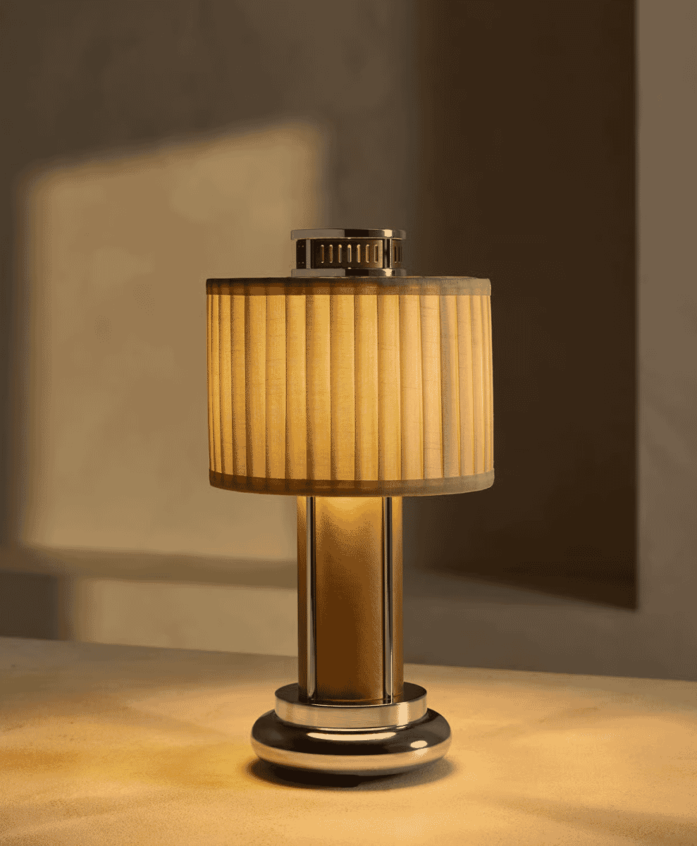 A vintage-style table lamp with a pleated beige shade emitting warm light.