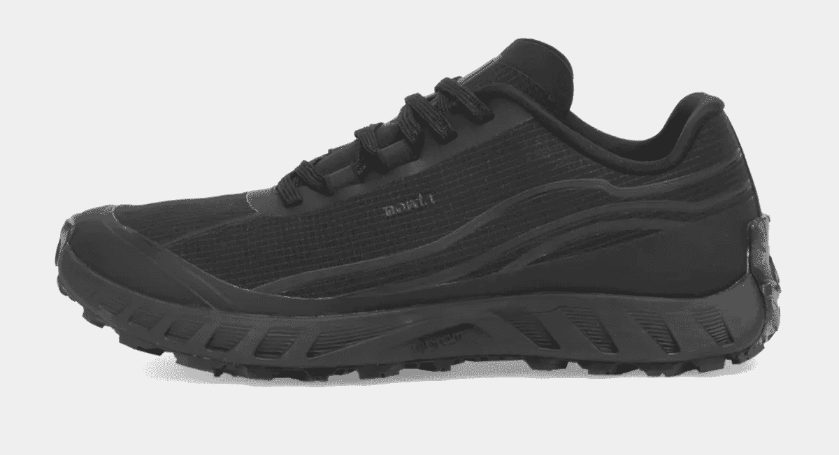 Sleek all-black trail running shoe with rugged outsole and NOMAD branding.