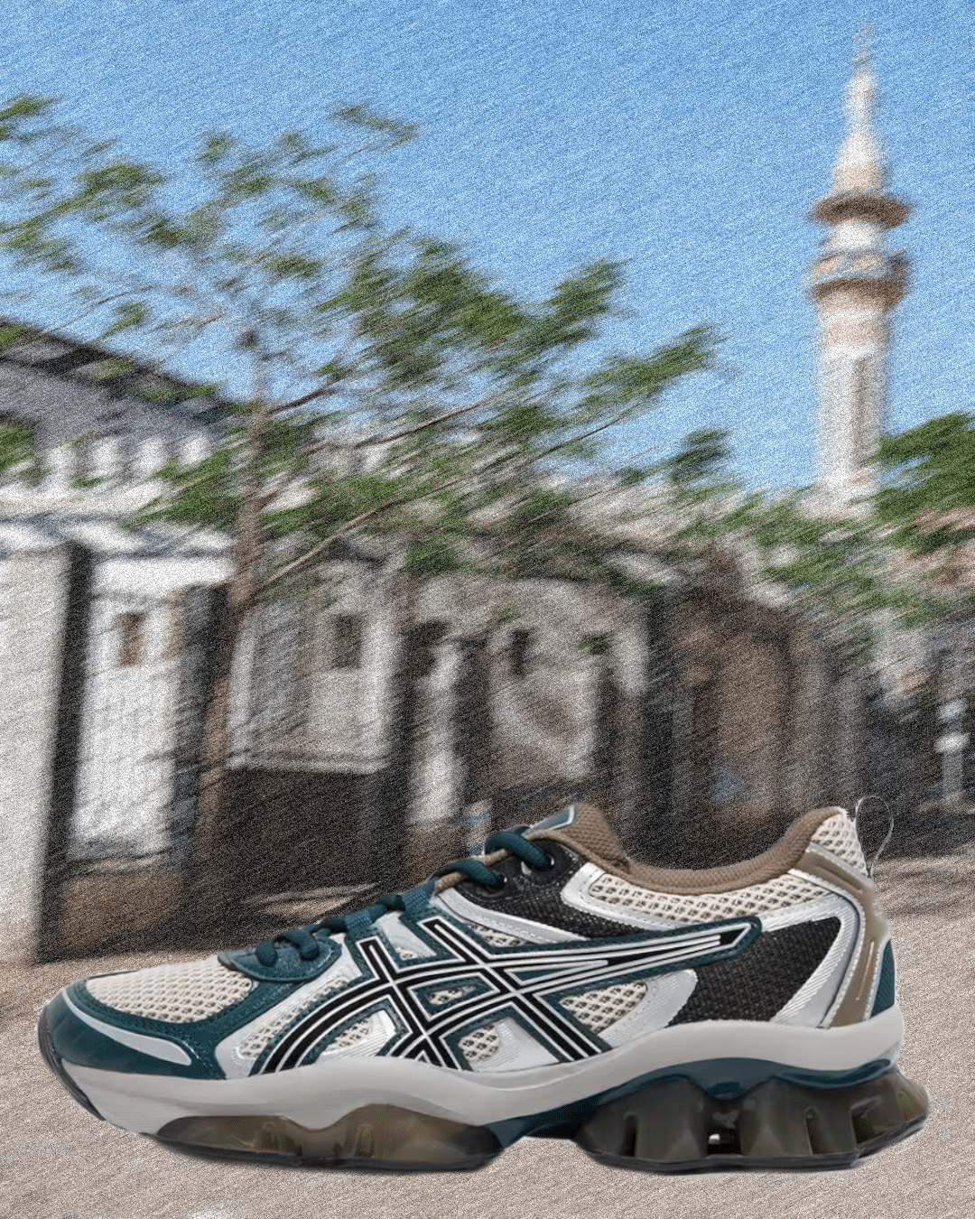 Close-up of a white and teal Asics shoe showing the cushioning system and mesh upper.