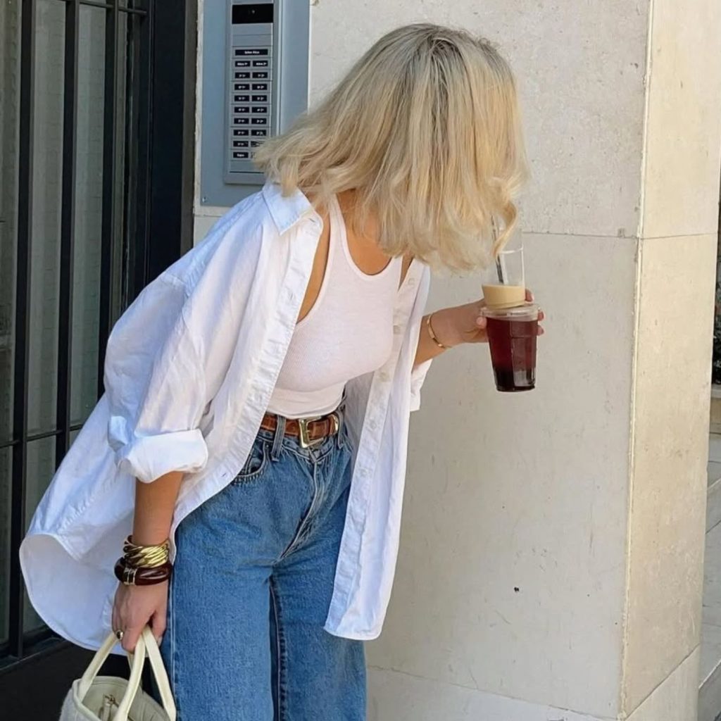 Laura Jade Stone styling a white tank top under an unbuttoned shirt.