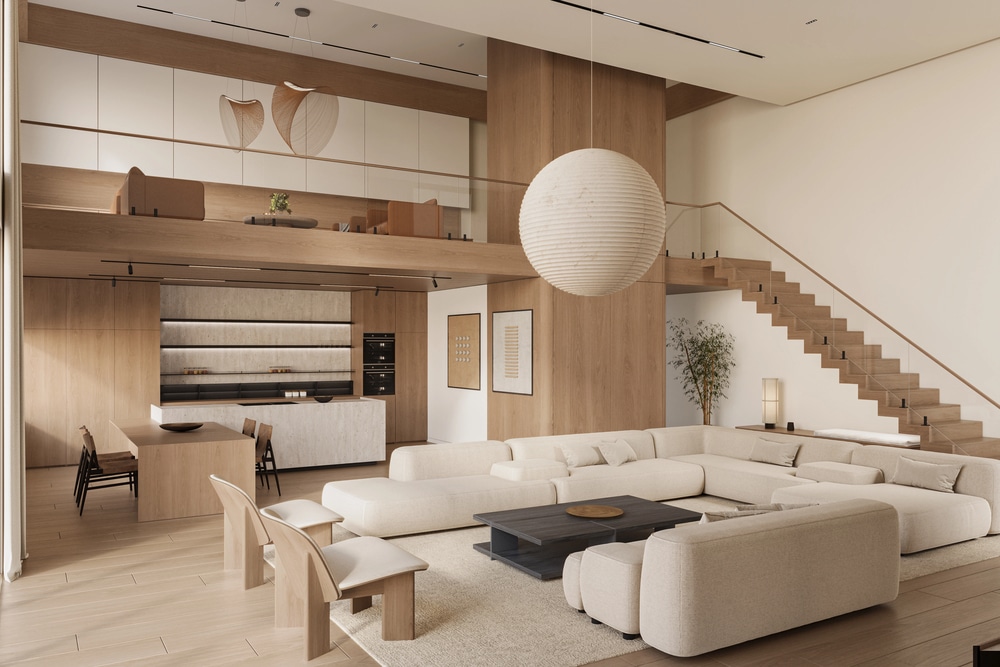 Minimalist living room featuring a neutral beige sectional and a modern wooden staircase.